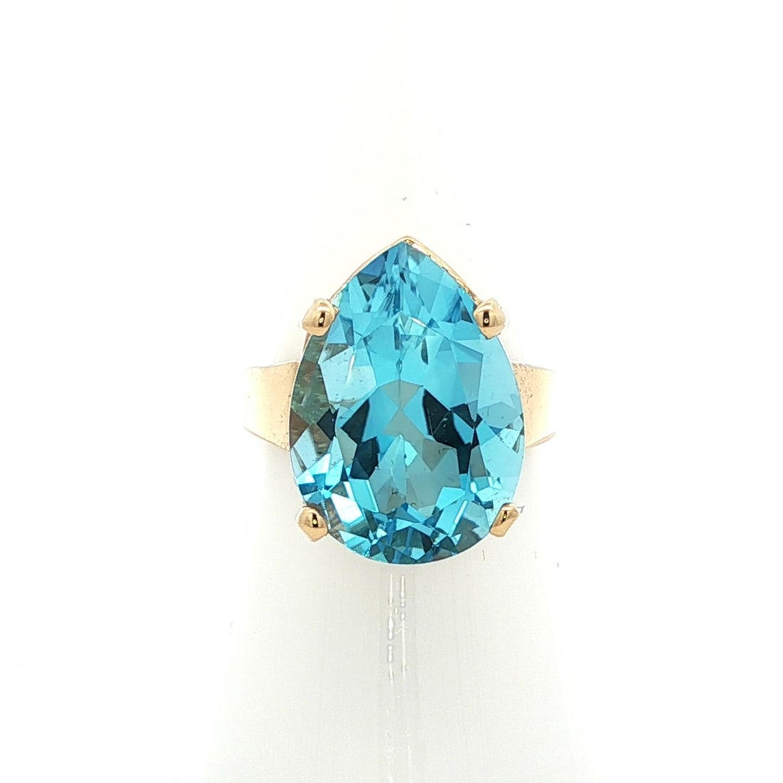 14k Yellow Gold Pear Cut Swiss Blue Topaz Cocktail Ring: 14k Yellow Gold Pear Cut Swiss Blue Topaz Cocktail Ring This stunning cocktail ring features a large pear-shaped Swiss blue topaz, crafted from solid 14k yellow gold. The natural gemstone measures app