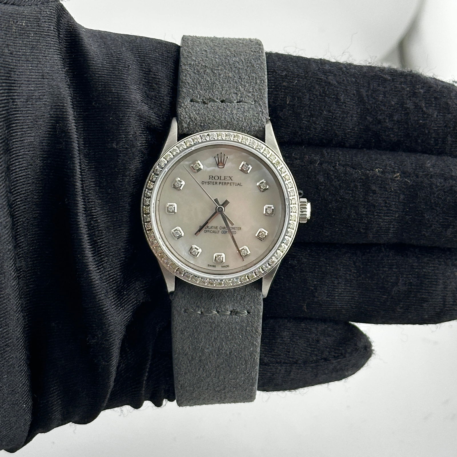 Reference 1005 Oyster Perpetual Watch With Aftermarket White MOP Dial and Leather Strap: Reference 1005 Oyster Perpetual Watch With Aftermarket White MOP Dial and Leather Strap This Rolex Oyster Perpetual features a white mother of pearl dial and a pave diamond bezel. The watch is paired