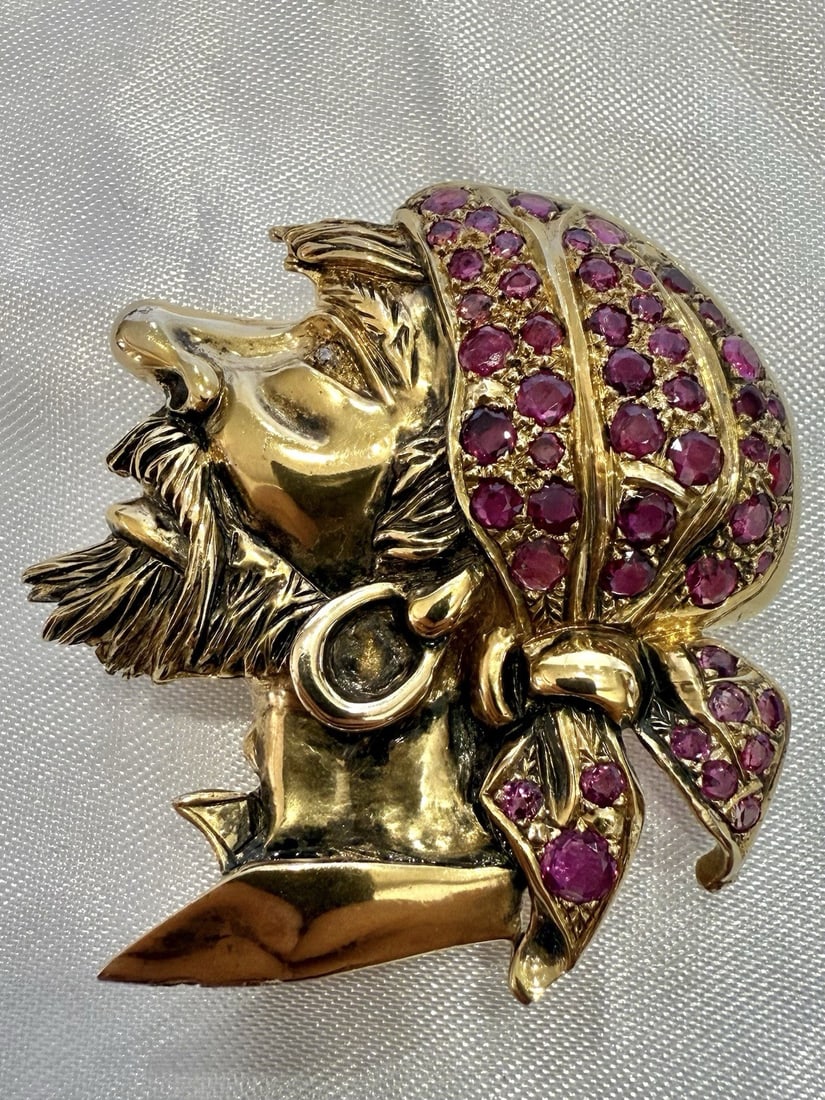 1960s 14K Yellow Gold Ruby Diamond Pirate Brooch: 1960s 14K Yellow Gold Ruby Diamond Pirate Brooch This exquisite 1960s brooch features a striking design of a pirate adorned with a kerchief crafted from vibrant red rubies. Made of 14K yellow gold, th