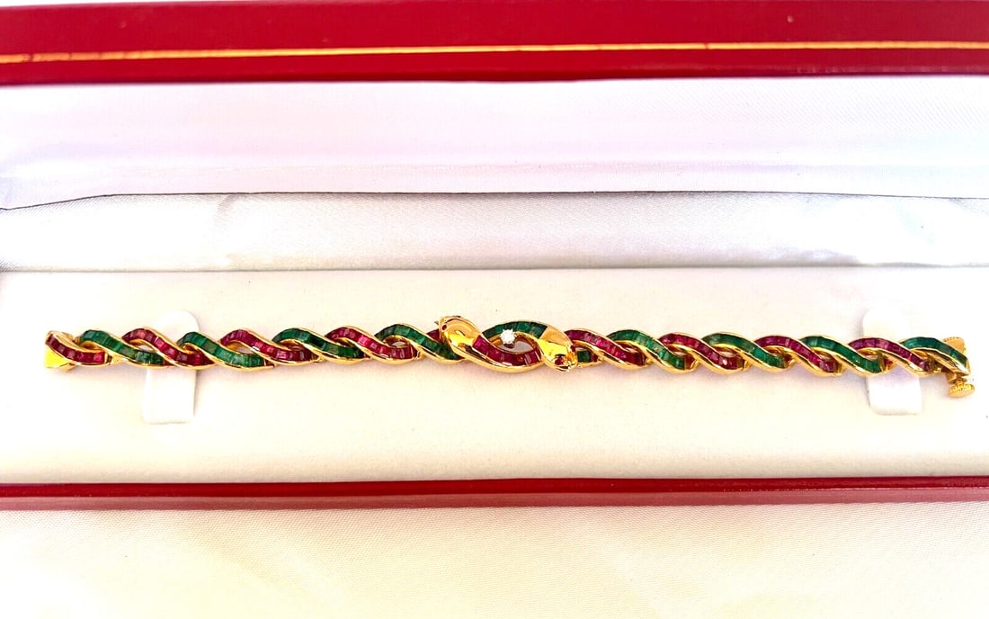 22K Yellow Gold Snake Bracelet with Rubies Emeralds Diamonds: 22K Yellow Gold Snake Bracelet with Rubies Emeralds Diamonds This exquisite 22K yellow gold bracelet features a stunning wrap design inspired by a snake, adorned with vibrant rubies, emeralds, and spa