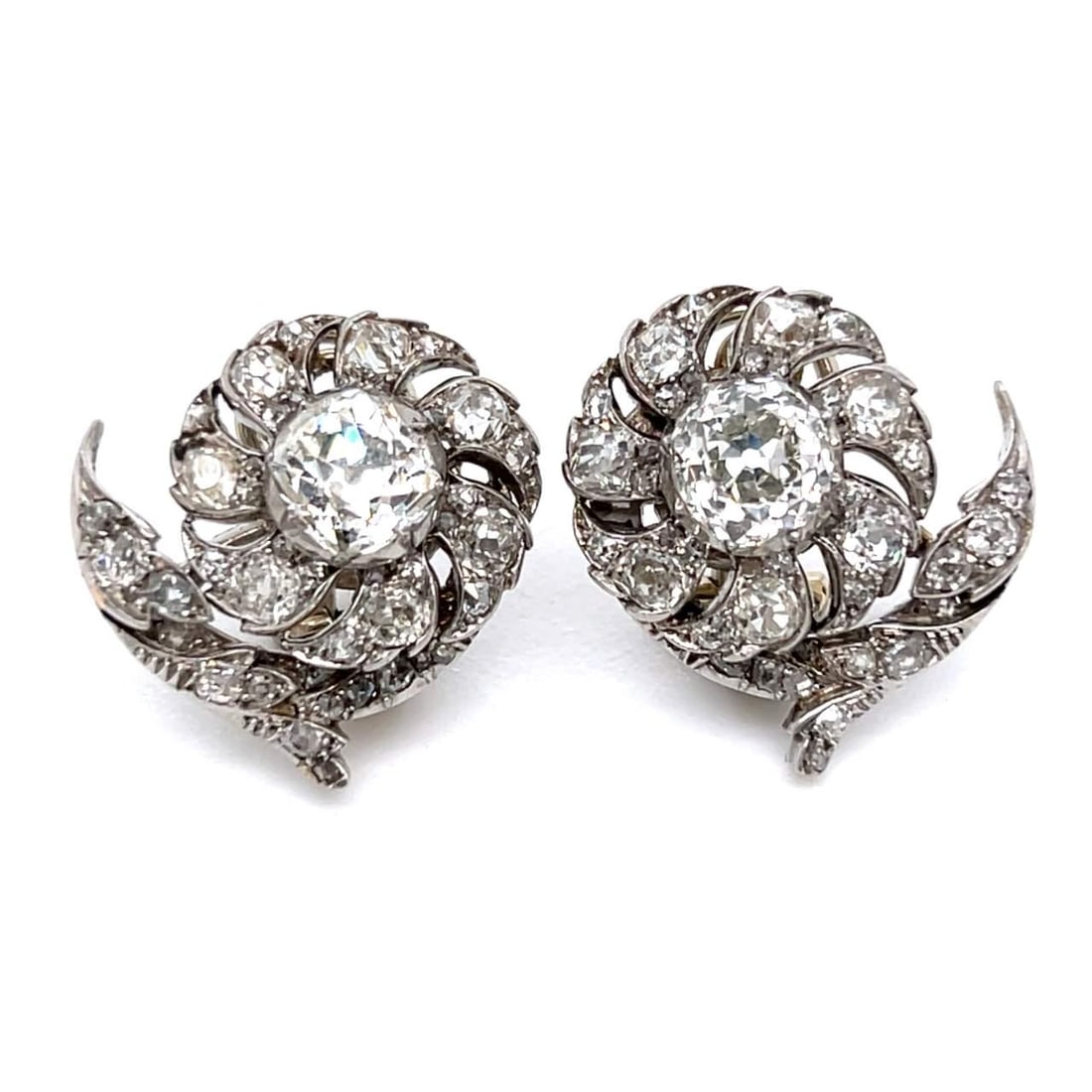 Art Deco Platinum 6.85 Ct Diamond Earrings with 2 Center Stones: Art Deco Platinum 6.85 Ct Diamond Earrings with 2 Center Stones These exquisite Art Deco earrings are crafted in platinum and feature a stunning total diamond weight of 6.85 carats. The earrings are s