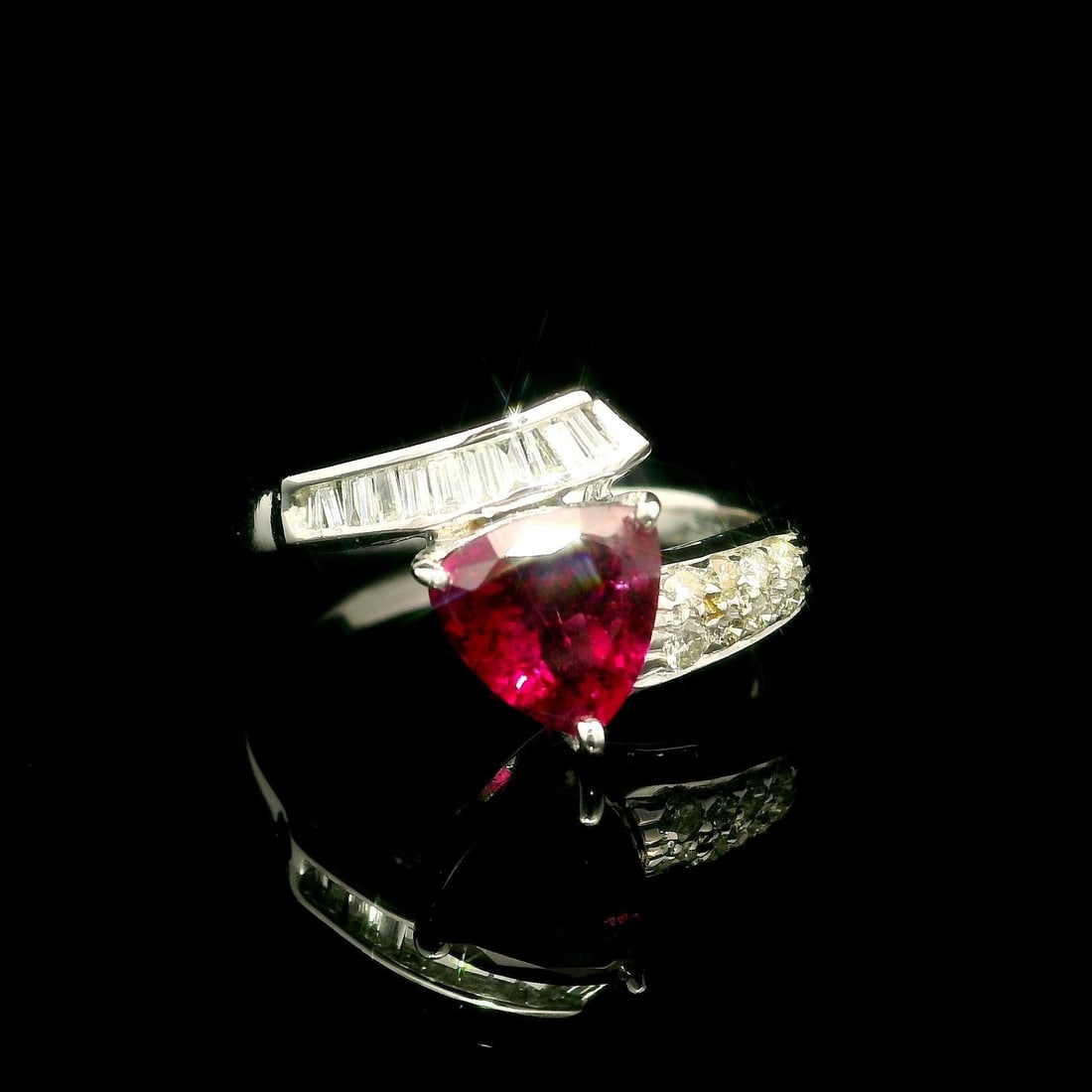 18k White Gold 1.45ct Rubellite Tourmaline Diamond Bypass Ring: 18k White Gold 1.45ct Rubellite Tourmaline Diamond Bypass Ring This exquisite bypass ring features a striking trillion-cut natural rubellite tourmaline, showcasing a deep vivid reddish-pink color with