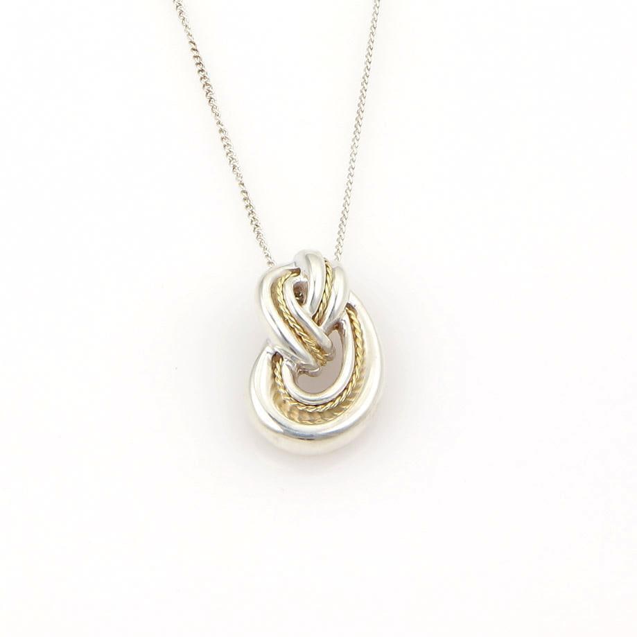 Tiffany & Co. Love Knot Pendant Sterling Silver 18k Gold with Chain: Tiffany & Co. Love Knot Pendant Sterling Silver 18k Gold with Chain Discover the timeless elegance of the Tiffany & Co. Love Knot Pendant, meticulously crafted in a stunning combination of 925 sterlin