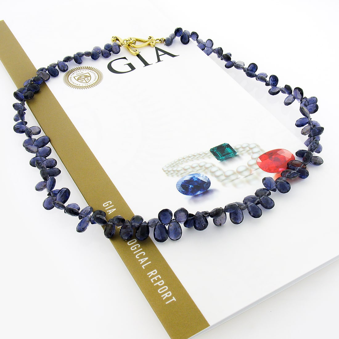 Vintage GIA Certified Iolite Tear Drop Necklace 18k Gold Clasp: Vintage GIA Certified Iolite Tear Drop Necklace 18k Gold Clasp This exquisite vintage strand necklace showcases a stunning array of tear drop briolette cut iolites, totaling approximately 70 carats in
