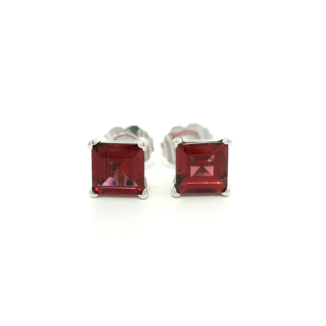 14k White Gold 1.78ctw Rhodolite Garnet Square Stud Earrings: 14k White Gold 1.78ctw Rhodolite Garnet Square Stud Earrings Enhance your elegance with these stunning stud earrings, featuring two natural genuine rhodolite garnets in a unique square step cut. Each