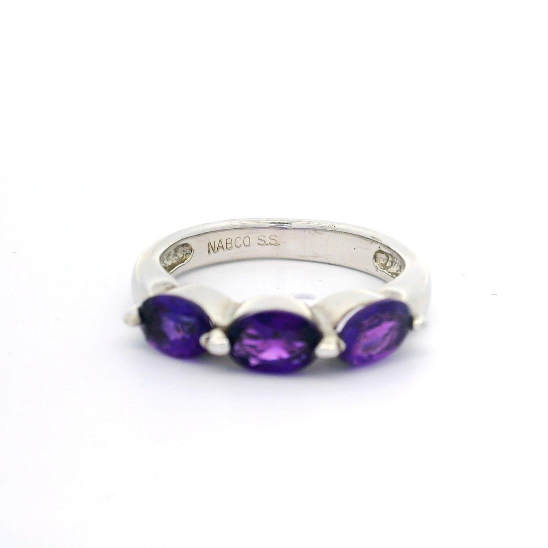 Sterling Silver Three Stone Oval Deep Purple Amethyst Ring: Sterling Silver Three Stone Oval Deep Purple Amethyst Ring This exquisite cocktail ring showcases a stunning design featuring three oval brilliant cut natural genuine amethysts, each measuring approxi