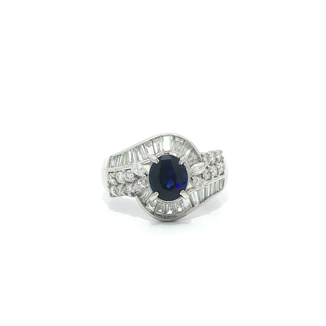 Platinum Ring with 2.45ctw Blue Oval Sapphire and Mixed Cut Diamonds: Platinum Ring with 2.45ctw Blue Oval Sapphire and Mixed Cut Diamonds This platinum cocktail ring features a natural oval-cut blue sapphire in a true royal blue color, weighing 1.39 carats and set in c