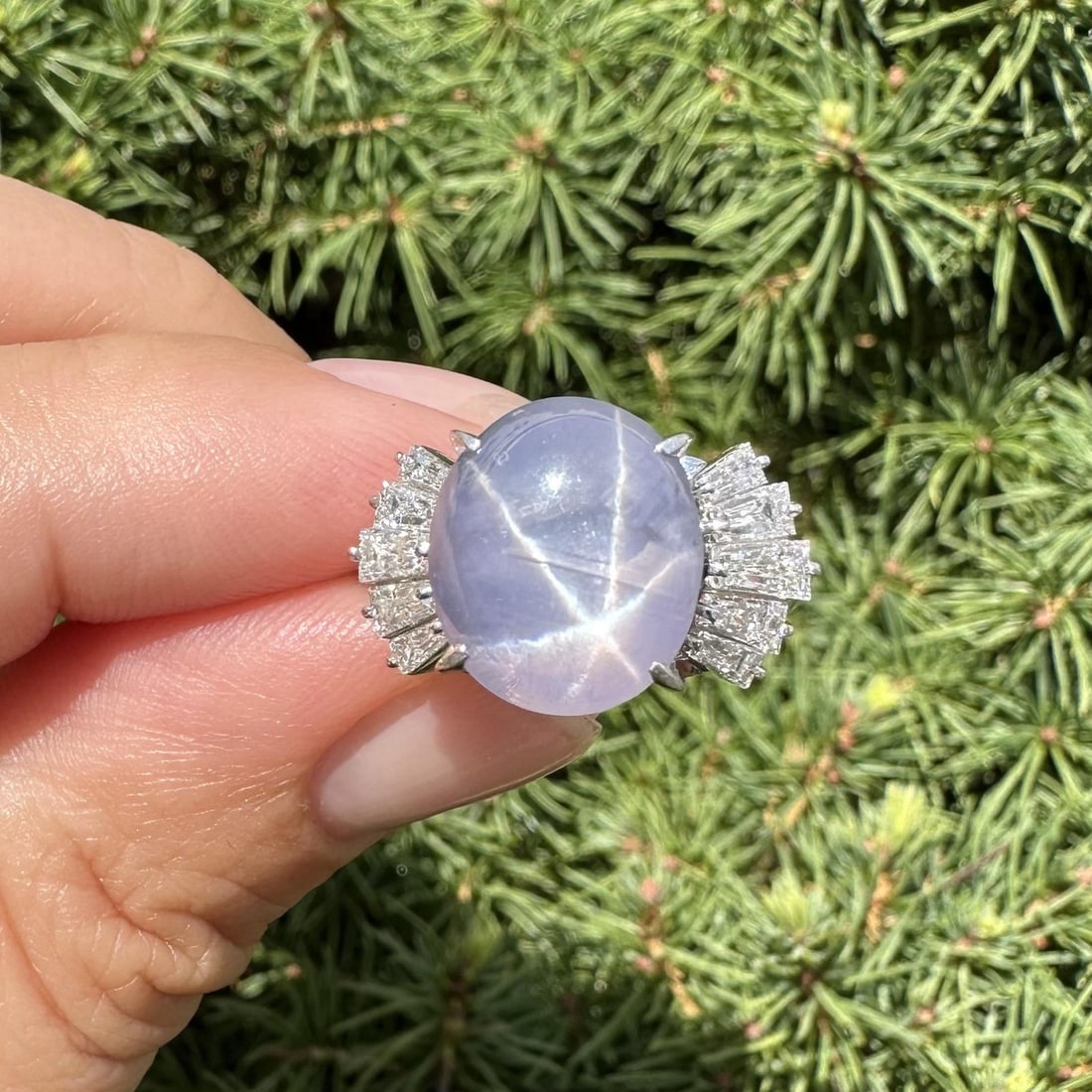 Platinum 10.95ctw Star Sapphire Baguette Diamond Cocktail Ring: Platinum 10.95ctw Star Sapphire Baguette Diamond Cocktail Ring This exquisite platinum ring showcases a stunning 10.04ct natural oval cabochon cut star sapphire in a beautiful grayish blue color, feat