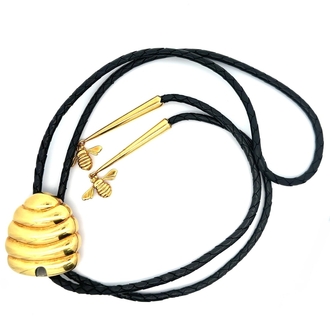 Gallen Benson 18k Gold Black Leather Bolo Tie Aiguillettes: Gallen Benson 18k Gold Black Leather Bolo Tie Aiguillettes Elevate your style with this vintage Gallen Benson Bee Hive bolo tie, expertly crafted from solid 18k yellow gold paired with a braided black