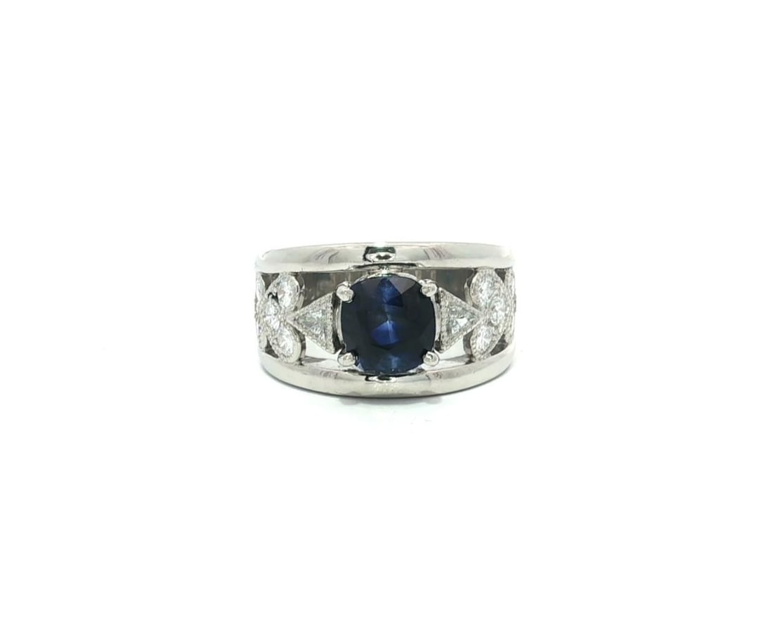 Platinum GIA 2.74ctw Cushion Blue Sapphire with Diamond Heart Band Ring: Platinum GIA 2.74ctw Cushion Blue Sapphire with Diamond Heart Band Ring This exquisite wide band ring showcases a stunning cushion-cut natural sapphire, weighing 2.10ct, in a vibrant royal blue color.