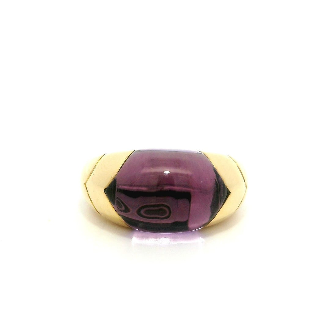 Bvlgari Tronchetto 18k Yellow Gold Amethyst Band Ring: Bvlgari Tronchetto 18k Yellow Gold Amethyst Band Ring This exquisite Bulgari Tronchetto band ring features a stunning custom cut natural amethyst, channel inlaid for a seamless look. The amethyst, mea