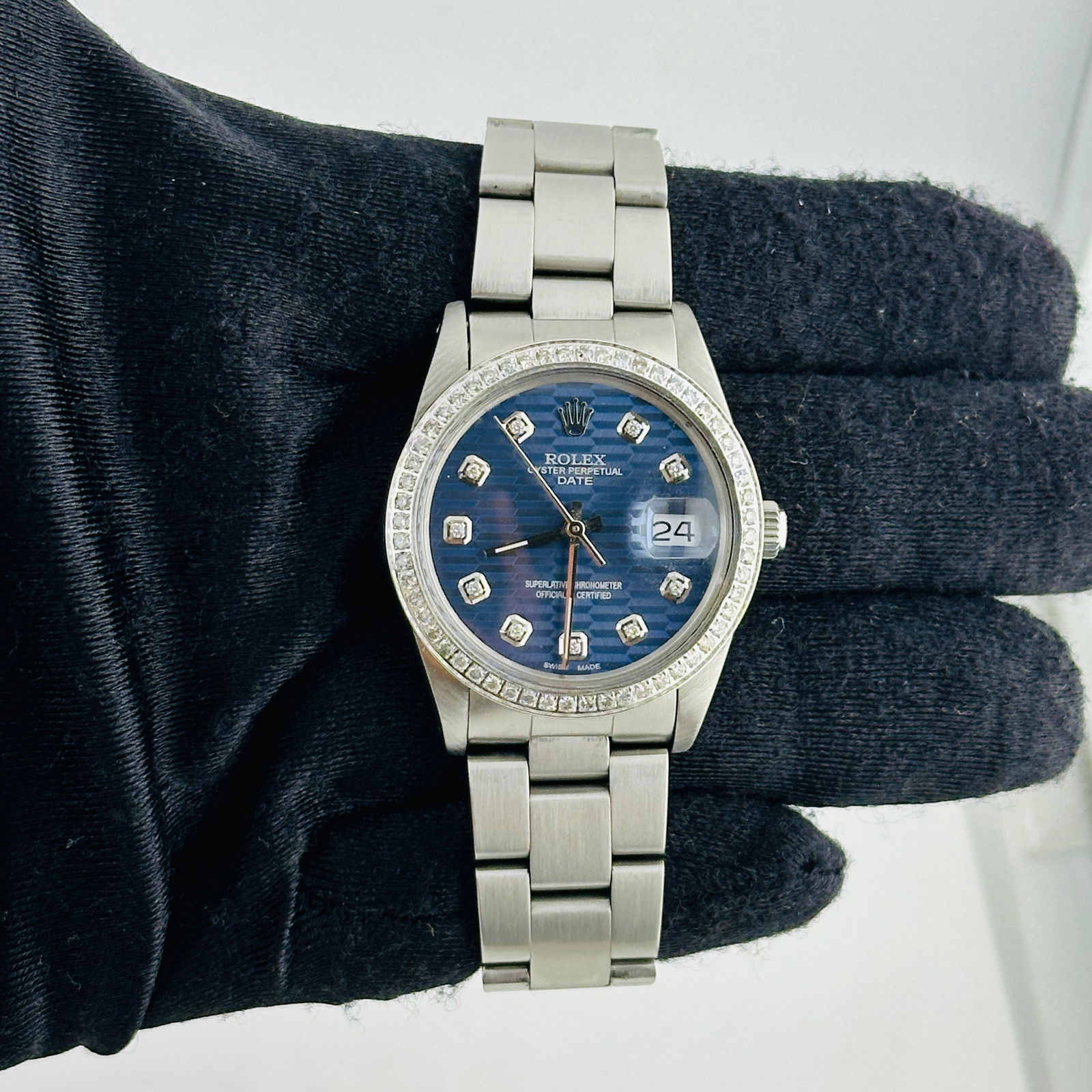 Rolex 15010 Unisex Oyster Perpetual Date Watch Aftermarket Blue Motif Dial: Rolex 15010 Unisex Oyster Perpetual Date Watch Aftermarket Blue Motif Dial This Rolex Oyster Perpetual Date watch features an Aftermarket blue motif dial and a pave diamond bezel. It is designed with