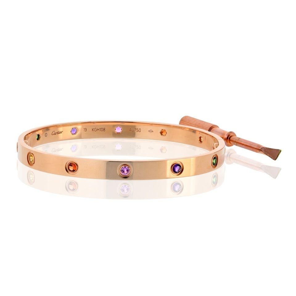Cartier Love 18K Rose Gold Multicolored Sapphire Bracelet Size 19: Cartier Love 18K Rose Gold Multicolored Sapphire Bracelet Size 19 Elevate your jewelry collection with this exquisite Cartier Love bracelet, meticulously crafted in 18K rose gold. This authentic pre-o