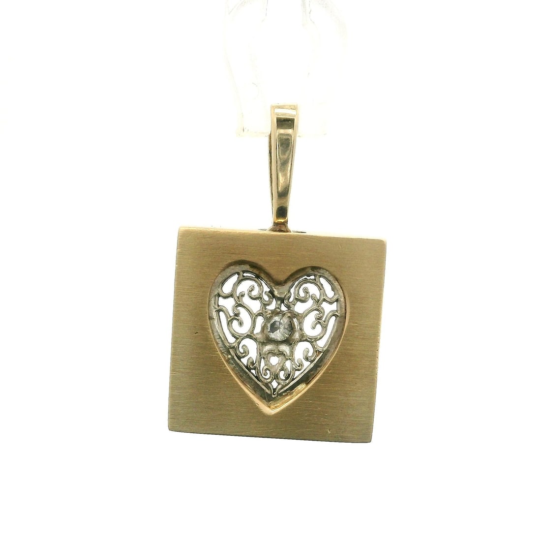 Vintage 14k Two-Tone Gold Filigree Heart Pendant with Diamond: Vintage 14k Two-Tone Gold Filigree Heart Pendant with Diamond This exquisite vintage pendant features a beautiful two-tone design, crafted from 14k yellow and white gold. The centerpiece is a