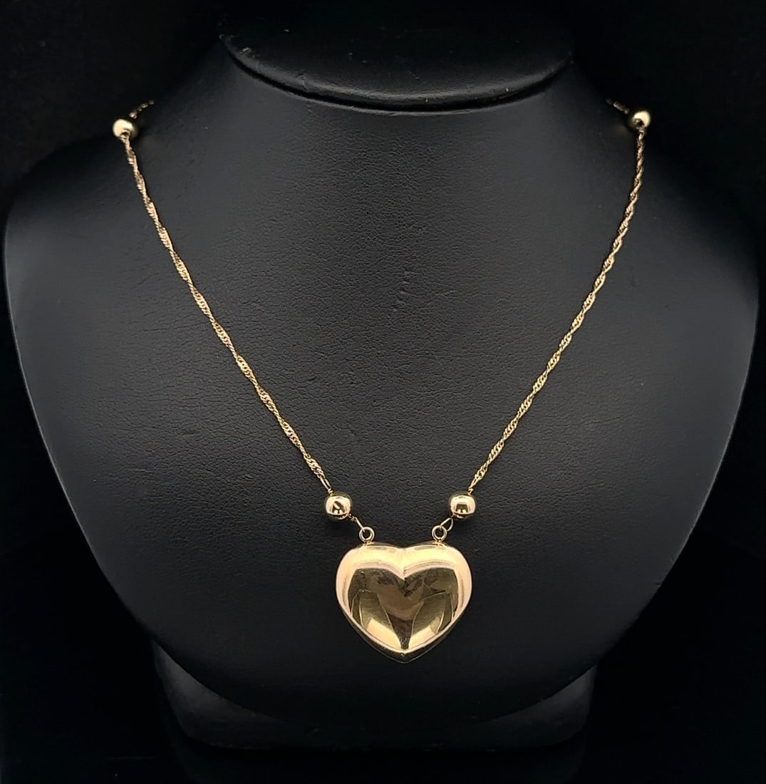 26 Inch 14k Yellow Gold Puffed Heart and Ball Station Rope Chain Necklace: 26 Inch 14k Yellow Gold Puffed Heart and Ball Station Rope Chain Necklace This elegant necklace features a 26-inch diamond cut fine rope chain crafted from solid 14k yellow gold, adorned with round be