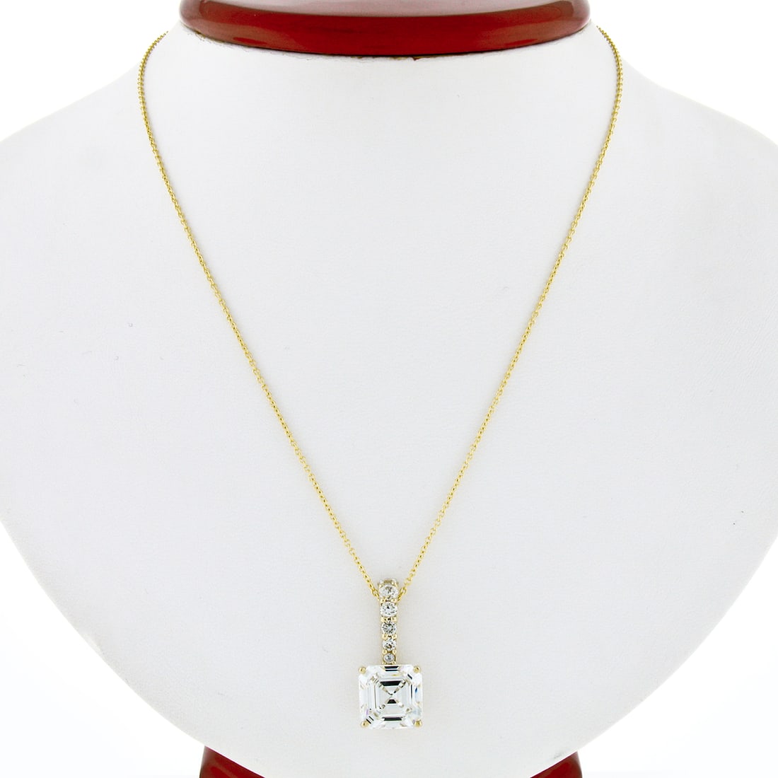 14K Yellow Gold Asscher Cut CZ Pendant Necklace with Round Accents: 14K Yellow Gold Asscher Cut CZ Pendant Necklace with Round Accents This exquisite pendant necklace showcases a stunning design crafted from high-quality solid 14K yellow gold. It features a striking l