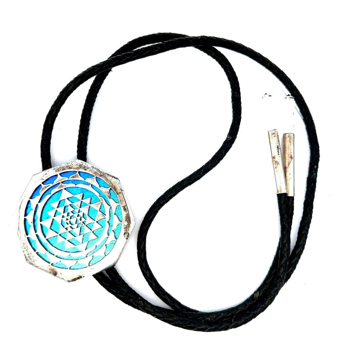 Mandala Bolo Tie with Sterling Silver and Painted Glass on Black Leather Cord: Mandala Bolo Tie with Sterling Silver and Painted Glass on Black Leather Cord This bolo tie features a sterling silver centerpiece with a gradient back-painted glass mandala design, mounted on a braid