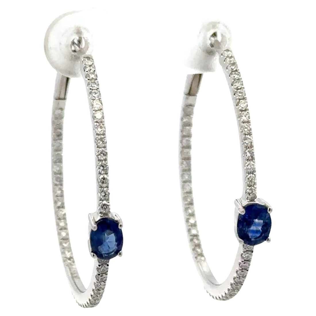 Contemporary 18K White Gold Hoop Earrings with Diamonds and Oval Blue Sapphires: Contemporary 18K White Gold Hoop Earrings with Diamonds and Oval Blue Sapphires These contemporary hoop earrings are crafted from 18K white gold and feature an inside-out design adorned with 88 round