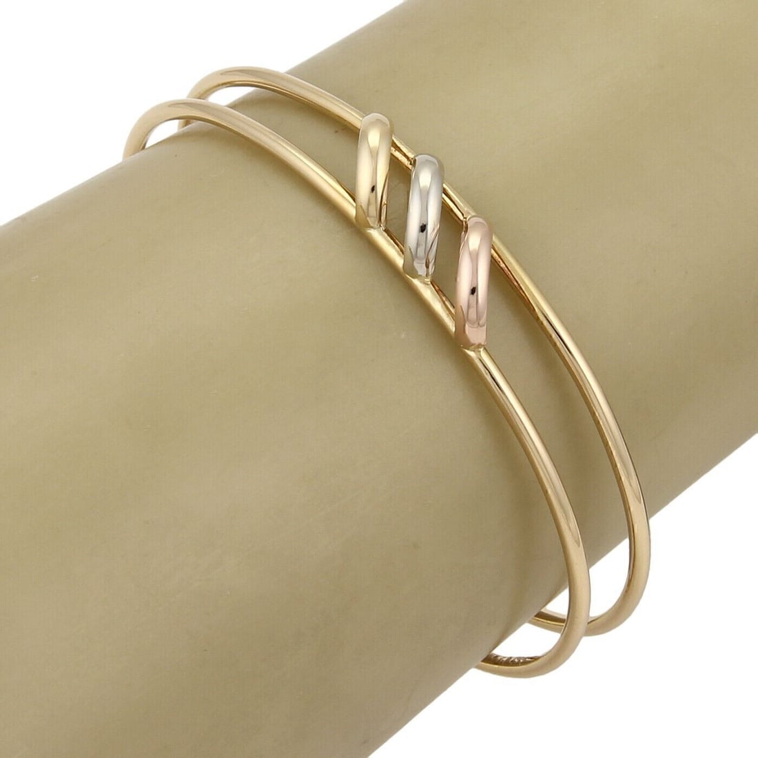 Trinity 18k Tri-Color Gold Double Wire Cuff Bracelet by Cartier with Paper: Trinity 18k Tri-Color Gold Double Wire Cuff Bracelet by Cartier with Paper This Cartier Trinity open double wire cuff bracelet is crafted from 18k yellow, rose, and white gold. Featuring Cartier's ico