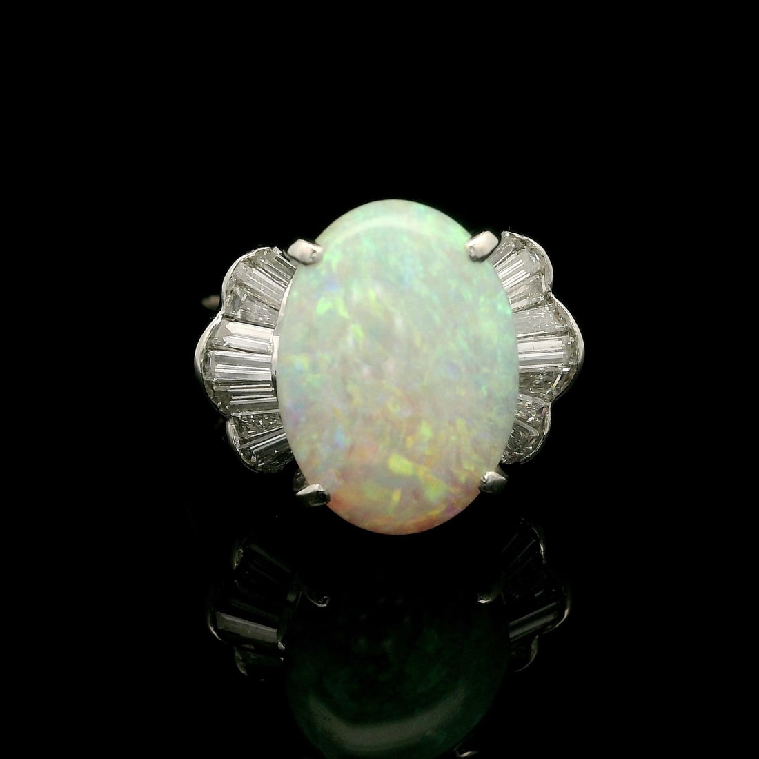 Platinum 4.6ctw Oval Opal Baguette Diamond Cocktail Ring: Platinum 4.6ctw Oval Opal Baguette Diamond Cocktail Ring This exquisite cocktail ring features a stunning 4.09ct natural Australian opal in an oval cabochon cut, showcasing a beautiful play of colors.