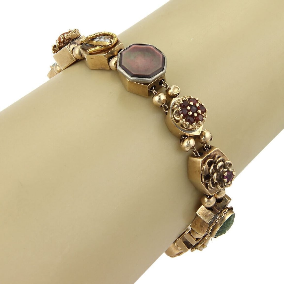 14k Yellow Gold Bracelet with Multicolor Gemstone Slide Charms: 14k Yellow Gold Bracelet with Multicolor Gemstone Slide Charms This charm link bracelet is crafted from 14k yellow gold and features an array of multicolor gemstones in various sizes. Designed with a