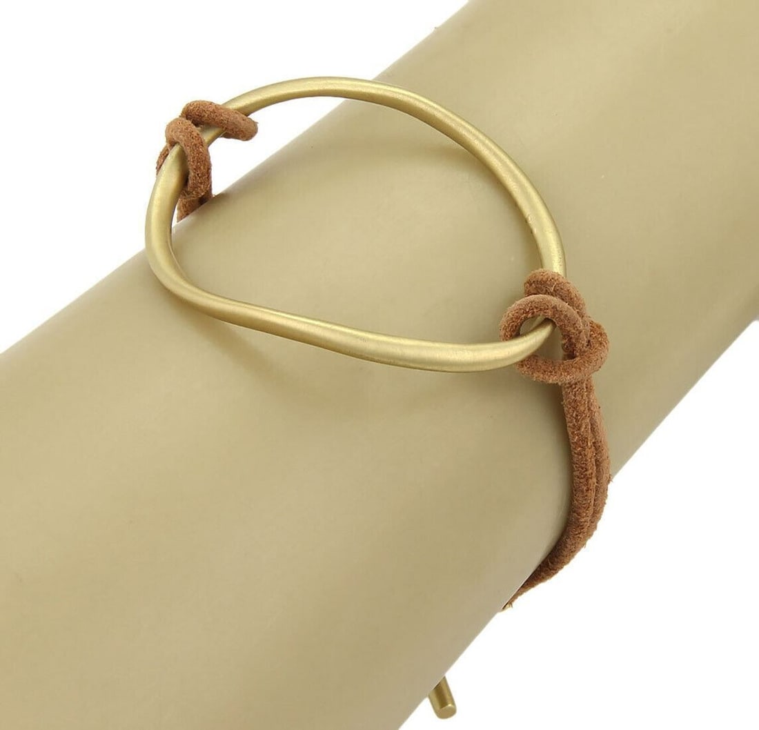 Fenestra 18k Yellow Gold Open Ring Bracelet with Suede Cord Toggle: Fenestra 18k Yellow Gold Open Ring Bracelet with Suede Cord Toggle This Slane & Slane Fenestra bracelet features an open ring design crafted from 18k yellow gold, paired with a suede cord toggle for a