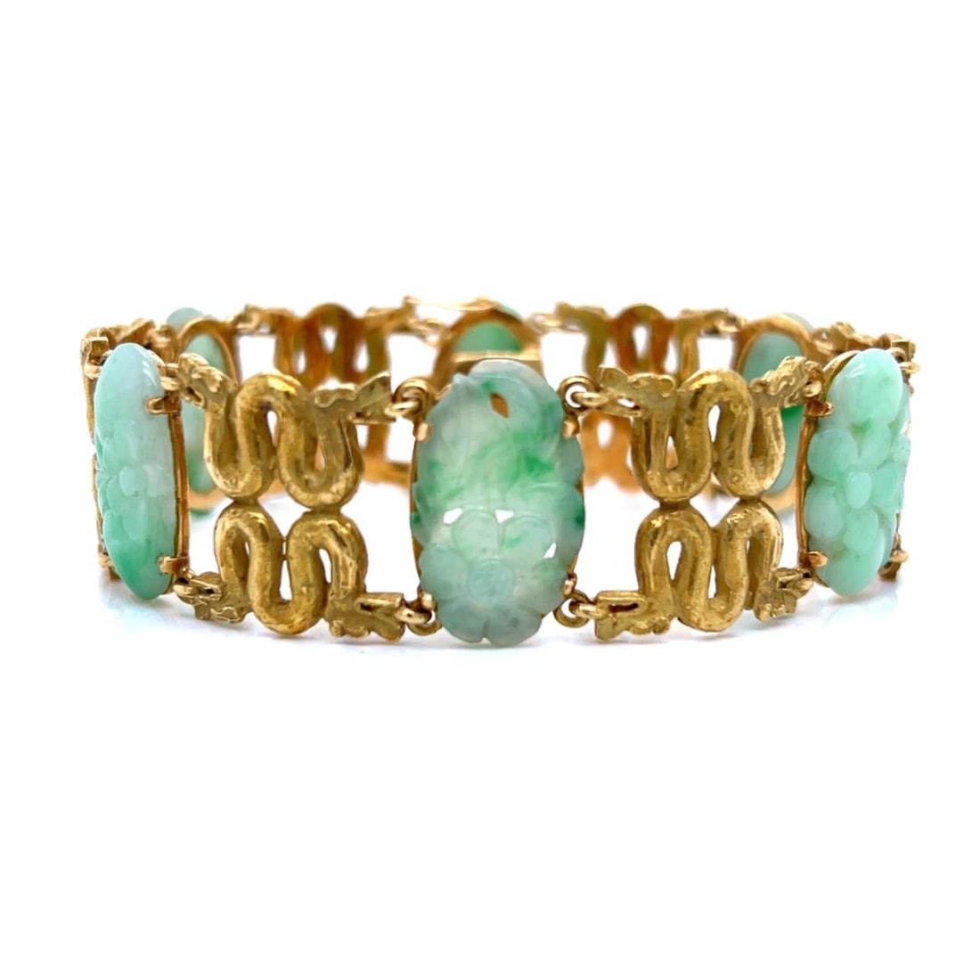 Carved Jade and 18K Yellow Gold Bracelet with Six Jade Stones 1960s: Carved Jade and 18K Yellow Gold Bracelet with Six Jade Stones 1960s This pre-owned bracelet from the 1960s features six carved jade stones set in 18K yellow gold. The bracelet weighs 50.9 grams and sh