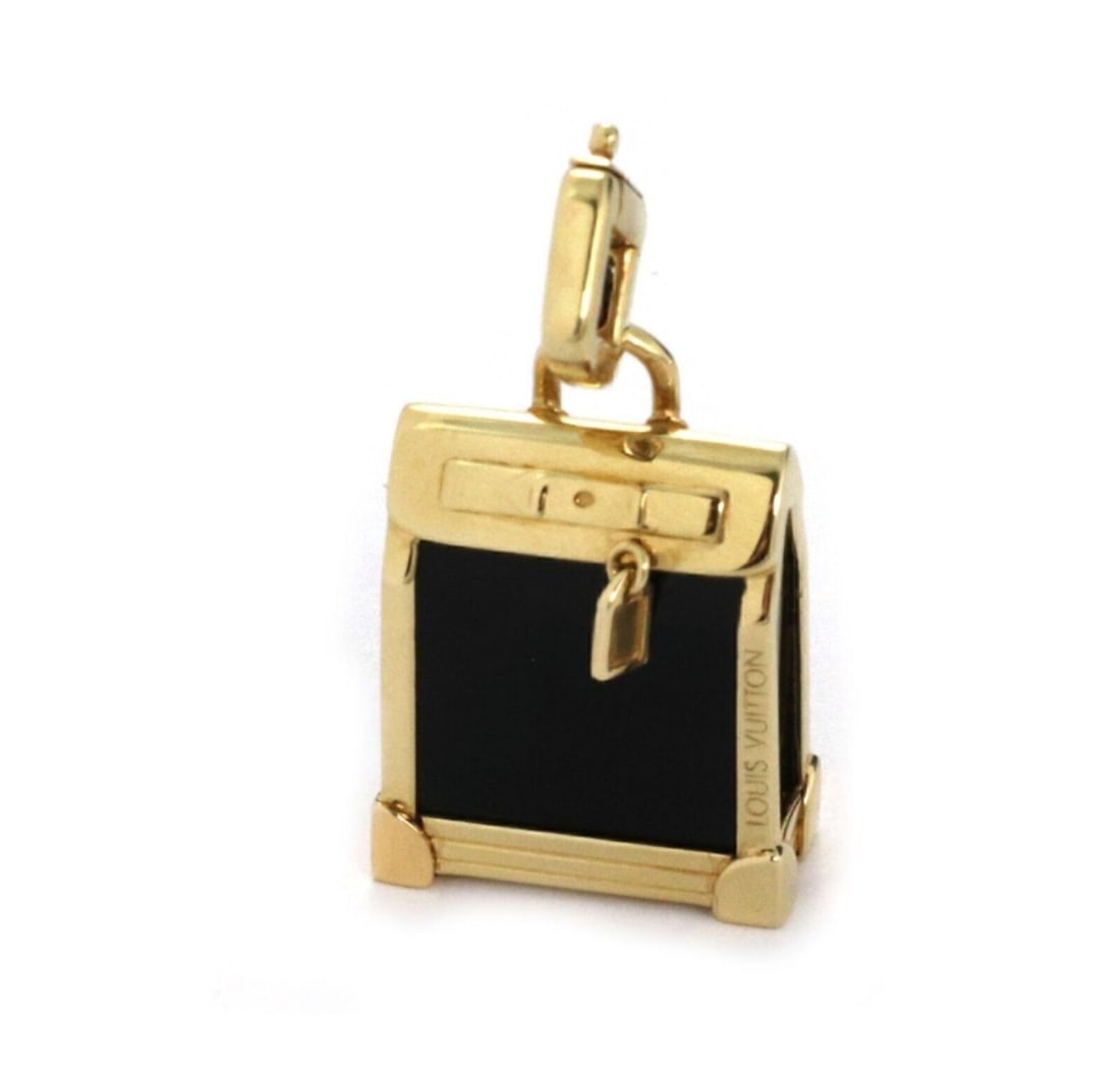 Steamer Collection Pendant in 18k Gold with Onyx by Louis Vuitton: Steamer Collection Pendant in 18k Gold with Onyx by Louis Vuitton This authentic Louis Vuitton Steamer Bag charm pendant is crafted from 18k yellow gold with a polished finish. The pendant features a