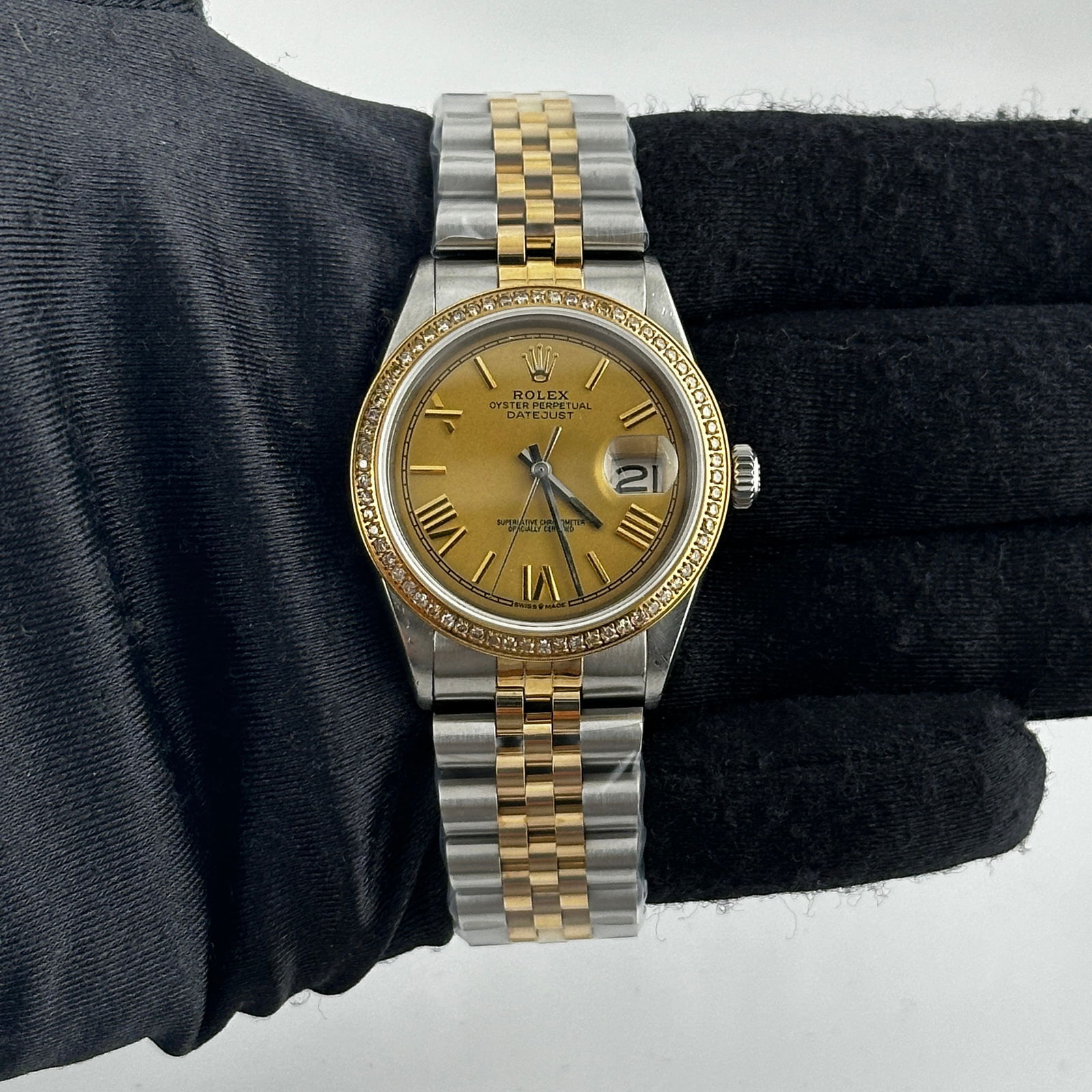 Champagne Roman Stick Dial Aftermarket Jubilee for Rolex Datejust 1601: Champagne Roman Stick Dial Aftermarket Jubilee for Rolex Datejust 1601 This is a men's Rolex Datejust watch, reference number 1601, featuring an aftermarket champagne dial with Roman stick markers. Th