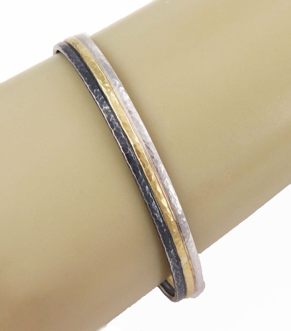 Sterling Silver Bangle Bracelet with 24k Gold Overlay by Gurhan Skittle: Sterling Silver Bangle Bracelet with 24k Gold Overlay by Gurhan Skittle This Gurhan Skittle bangle bracelet showcases a sophisticated design with a 24k gold overlay on sterling silver, offering a stri
