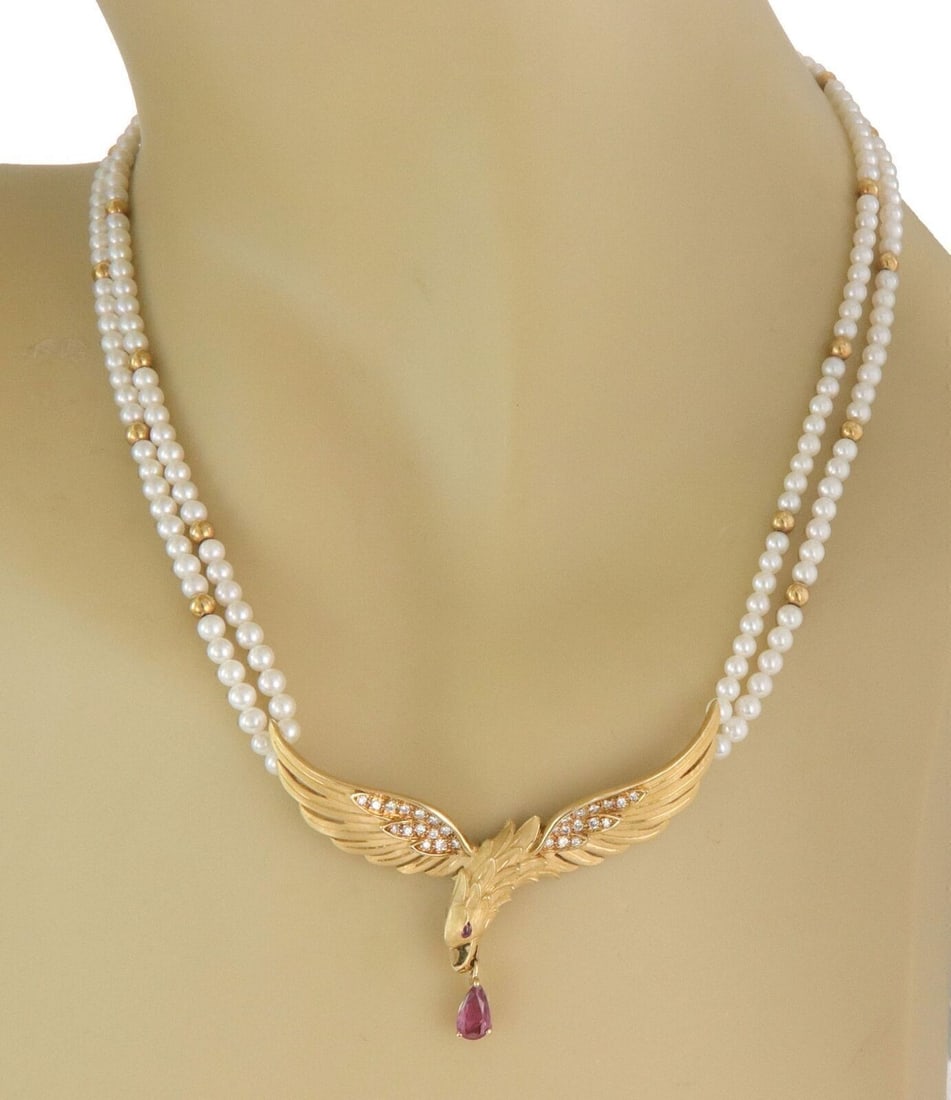 Eagle Pendant Necklace With Pearls Rubies Diamonds In 18k Yellow Gold By Carrera y Carrera: Eagle Pendant Necklace With Pearls Rubies Diamonds In 18k Yellow Gold By Carrera y Carrera This Carrera y Carrera necklace is crafted from 18k yellow gold and features a striking eagle pendant