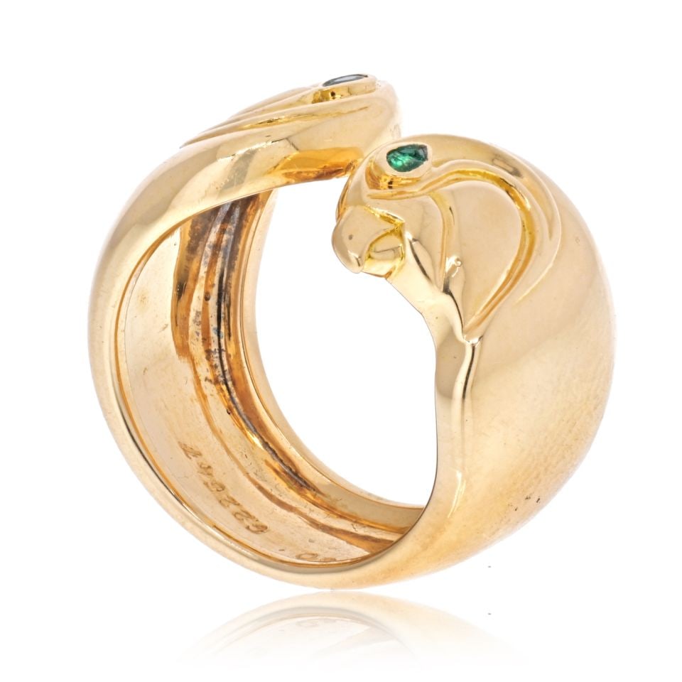 Cartier 18K Yellow Gold Anoubois Falcon Head Ring with Emerald Eyes: Cartier 18K Yellow Gold Anoubois Falcon Head Ring with Emerald Eyes This exquisite vintage Cartier ring features a striking design inspired by ancient Egyptian aesthetics. Crafted in the 1980s, this p