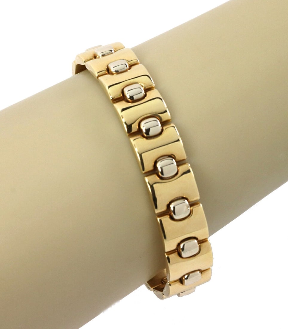 Italian 18k Yellow and White Gold 12mm Link Bracelet by Kria: Italian 18k Yellow and White Gold 12mm Link Bracelet by Kria This elegant flexible link bracelet by Italian designer Kria is crafted from 18k yellow and white gold. It features a 12mm wide design with