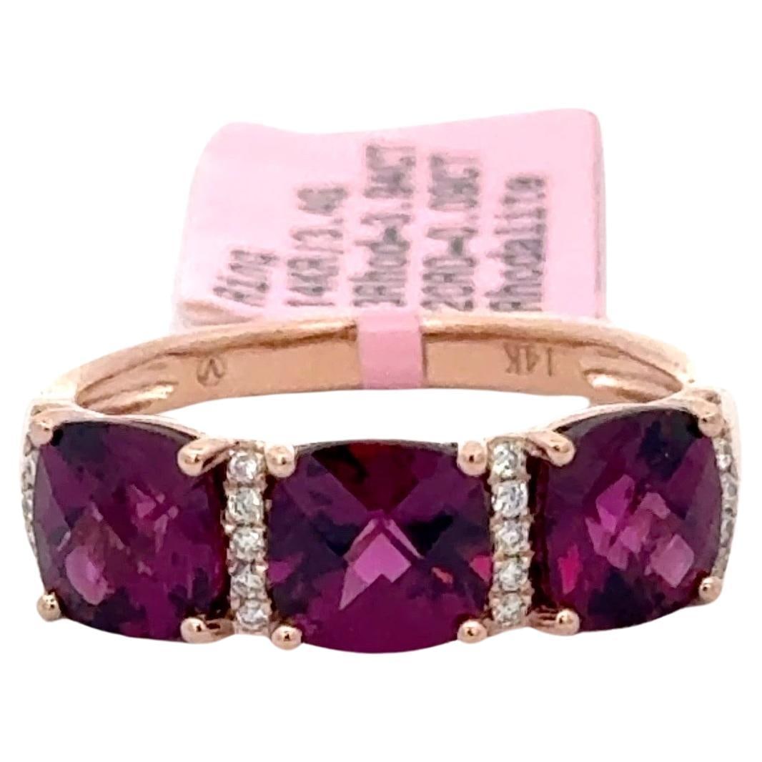 14K Yellow Gold Rhodolite Diamond Band Ring 3 Stone 4.15 CTTW: 14K Yellow Gold Rhodolite Diamond Band Ring 3 Stone 4.15 CTTW This exquisite band ring features a stunning design crafted in 14 karat yellow gold. The ring showcases three cushion cut faceted rhodolit