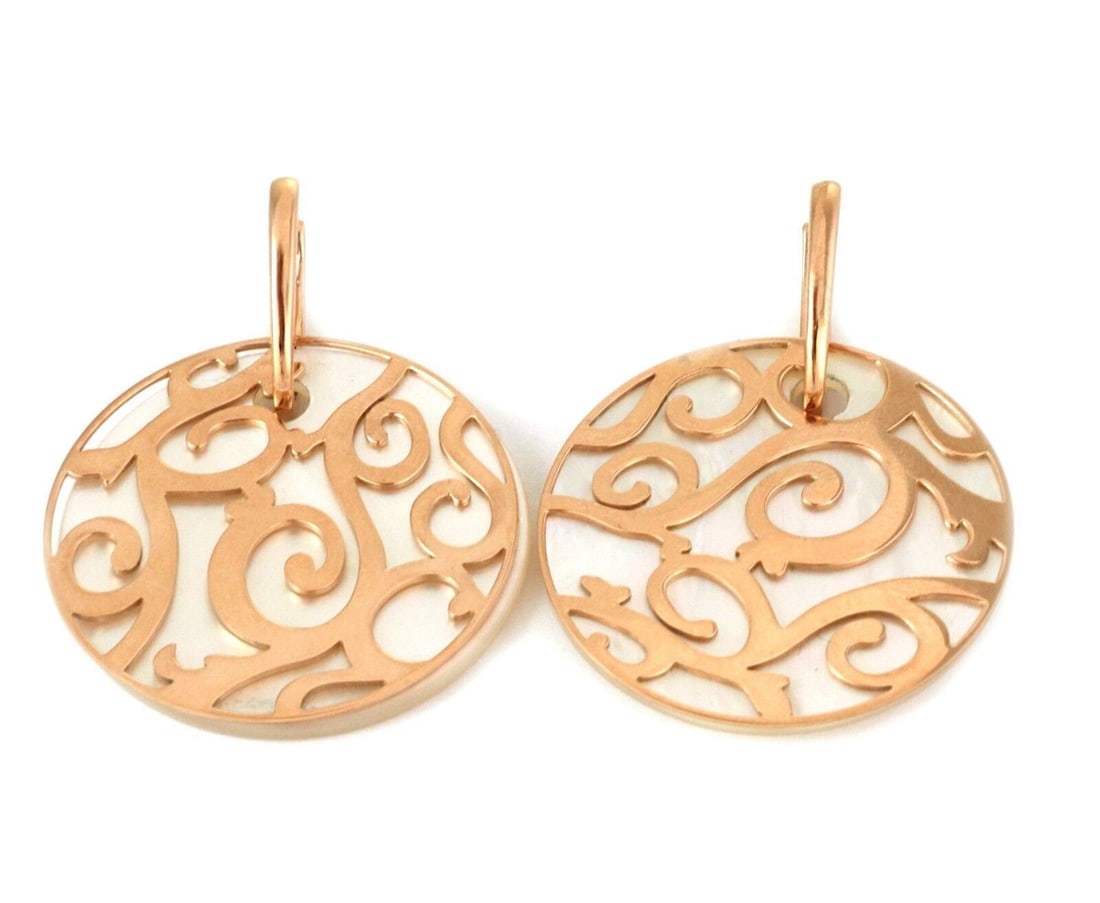 Siriana 18k Rose Gold Mother of Pearl Drop Earrings by Mattioli: Siriana 18k Rose Gold Mother of Pearl Drop Earrings by Mattioli These Mattioli Siriana dangle earrings are crafted from 18k rose gold and feature a high-polished lattice disc design. Each earring show