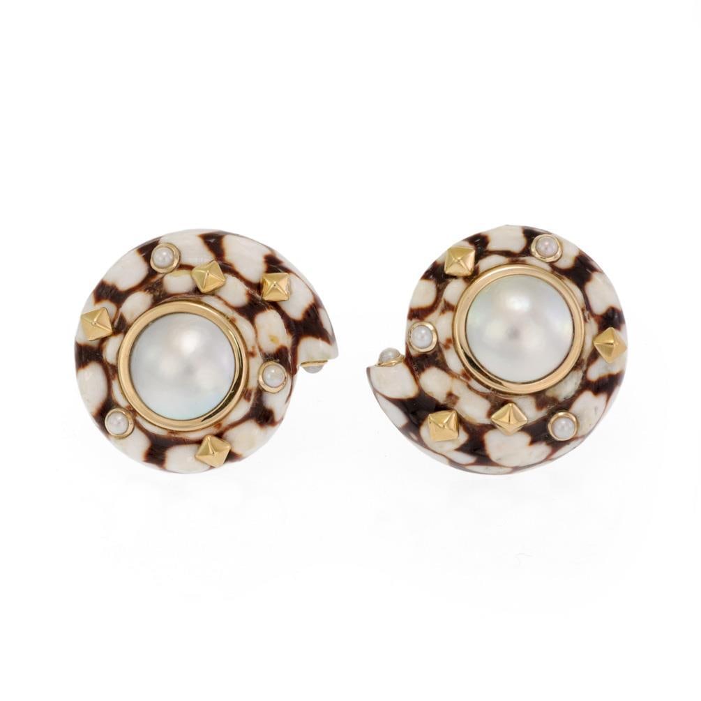 Trianon 14k Yellow Gold Clip-On Earrings with Mabe Pearl and Spiral Shell: Trianon 14k Yellow Gold Clip-On Earrings with Mabe Pearl and Spiral Shell Exquisite Trianon clip-on earrings that showcase a unique spiral shell design. Crafted from 14k yellow gold, these earrings fe
