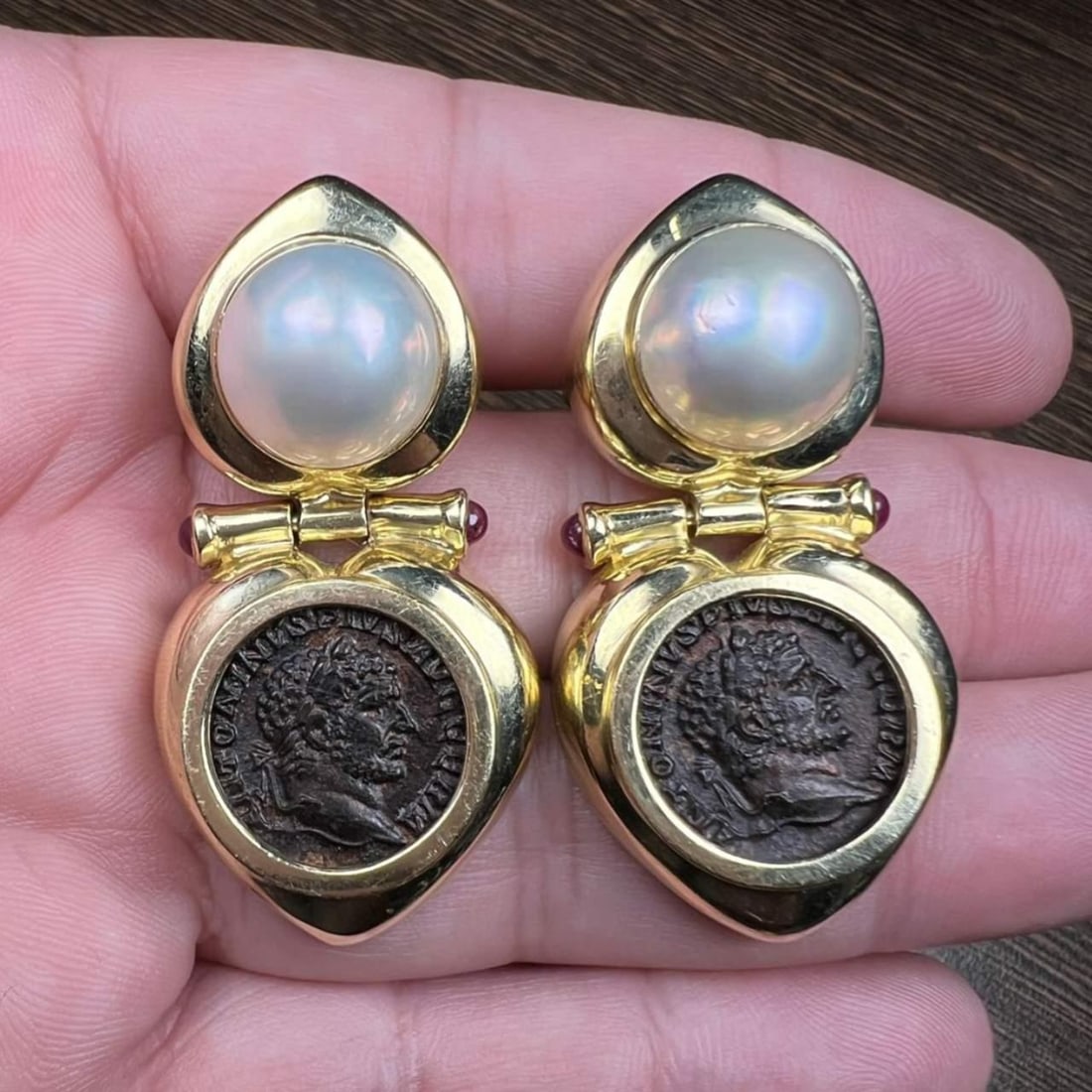 14K Yellow Gold Roman Coin Mabe Pearl Ruby Earrings 1.75 inches: 14K Yellow Gold Roman Coin Mabe Pearl Ruby Earrings 1.75 inches These exquisite earrings feature a captivating design crafted from 14K yellow gold. Each earring showcases two stunning Mabe pearls, eac