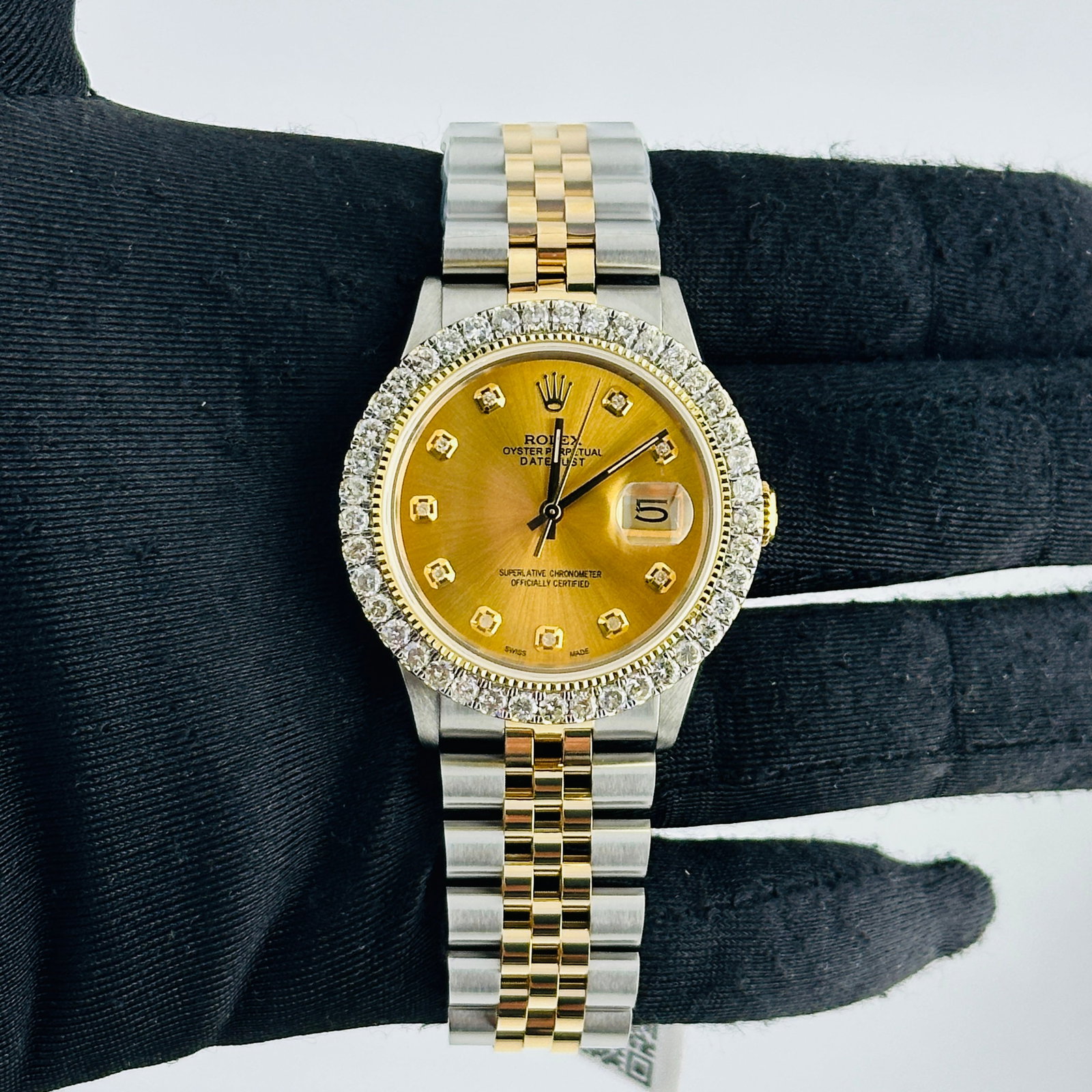 Champagne Diamond Dial Aftermarket Jubilee Rolex Datejust 16013: Champagne Diamond Dial Aftermarket Jubilee Rolex Datejust 16013 This Rolex Datejust features an aftermarket champagne diamond dial and an aftermarket Jubilee bracelet. The watch has a prong-plated dia