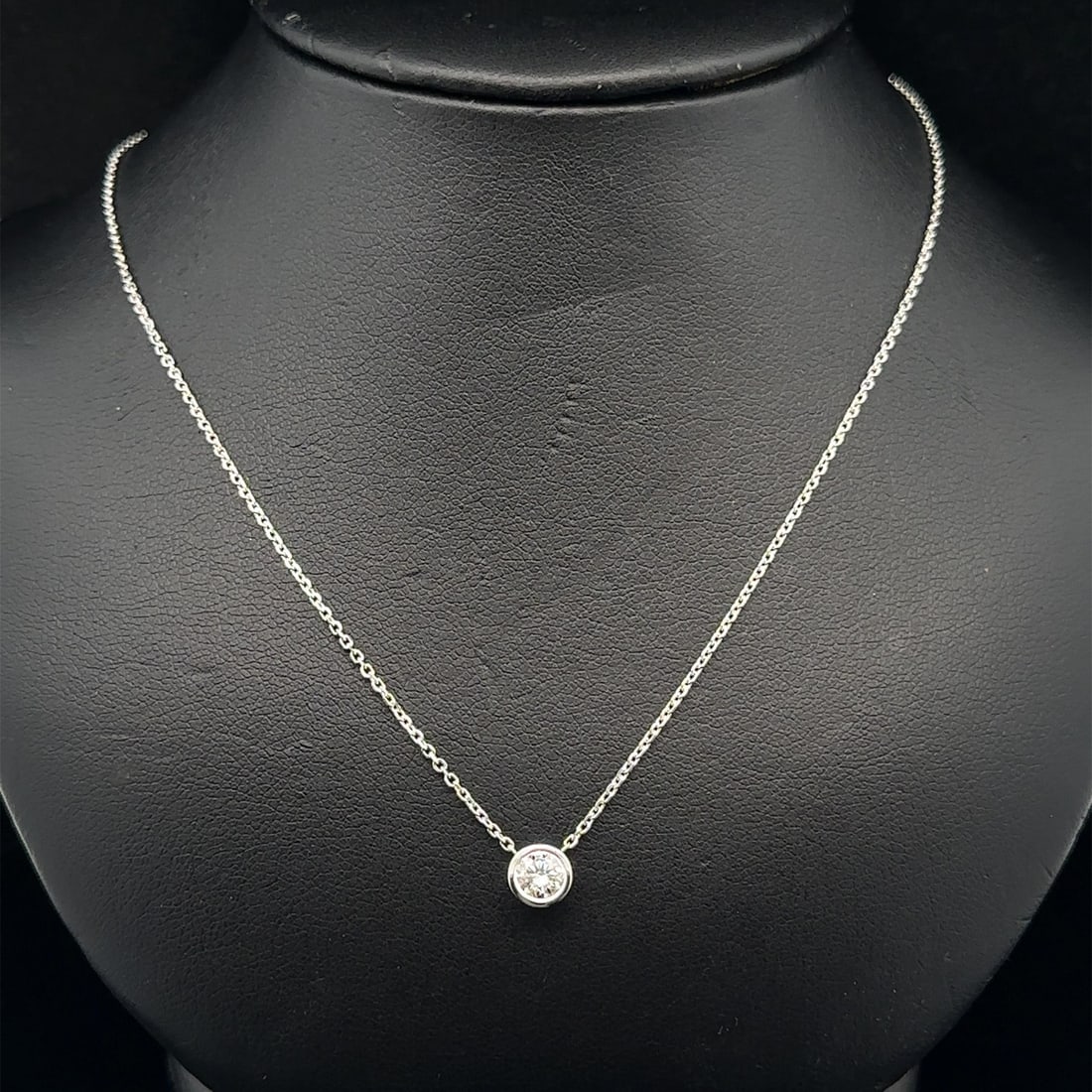 14k White Gold Bezel Set 0.33ct Diamond Solitaire Pendant Necklace: 14k White Gold Bezel Set 0.33ct Diamond Solitaire Pendant Necklace This un-used necklace features a 0.33 carat natural round brilliant diamond set in a bezel setting, crafted from solid 14k white gold