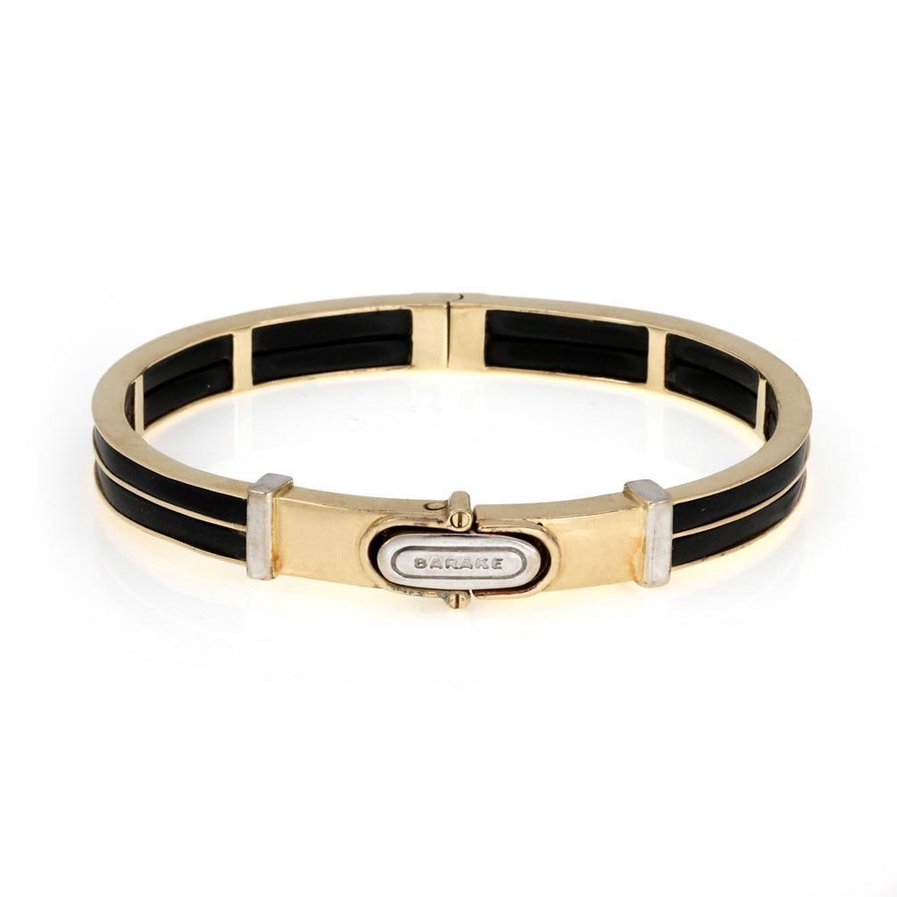 Men's Barake 14k Two Tone Gold Bracelet with Black Rubber: Men's Barake 14k Two Tone Gold Bracelet with Black Rubber This striking men's bangle bracelet combines elegance and modern design, crafted from 14k yellow and white gold. The bracelet features a uniqu