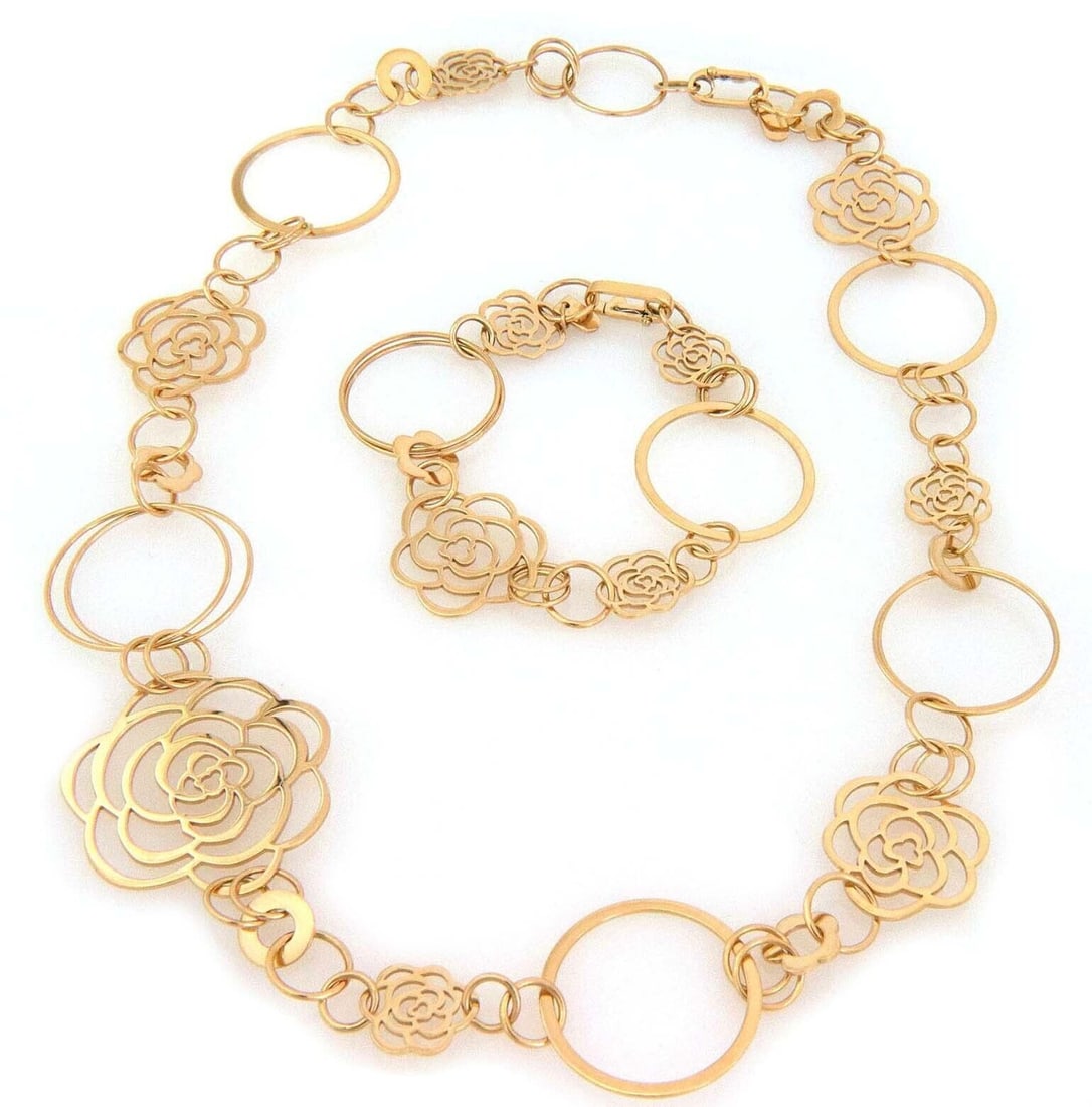 Chanel Camellia Motif 18k Yellow Gold Necklace and Bracelet Jewelry Set with Papers: Chanel Camellia Motif 18k Yellow Gold Necklace and Bracelet Jewelry Set with Papers This authentic Chanel Camellia jewelry set features a matching necklace and bracelet crafted from 18k yellow gold. B