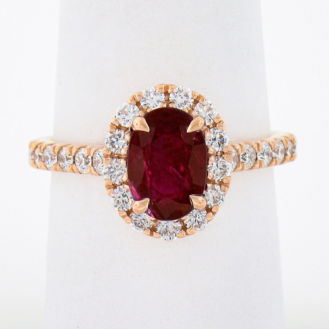 14k Rose Gold GIA Certified 2.34ct Oval Ruby Diamond Halo Engagement Ring: 14k Rose Gold GIA Certified 2.34ct Oval Ruby Diamond Halo Engagement Ring This exquisite engagement ring showcases a stunning 2.34 carat GIA certified natural ruby, known for its deep red hue and oval