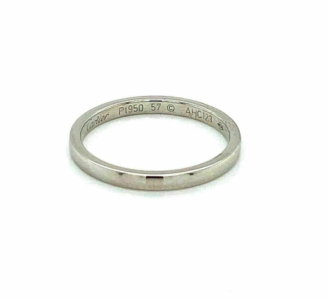 Platinum 2mm Band Ring by Cartier in Size 6: Platinum 2mm Band Ring by Cartier in Size 6 This authentic Cartier wedding band ring is expertly crafted in platinum with a high-polish finish. Featuring a classic 2mm wide domed design, it offers ele