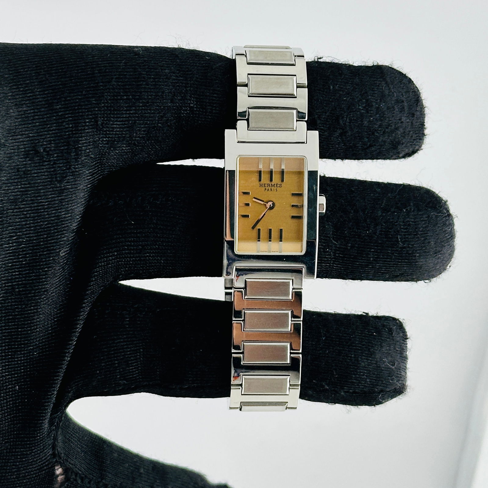 Hermes TA1.210 Tandem Watch with Salmon Color Dial 19mm Stainless Steel: Hermes TA1.210 Tandem Watch with Salmon Color Dial 19mm Stainless Steel This is a Hermes Tandem wristwatch featuring a salmon-colored dial and reference number TA1.210. The case measures 19mm and is c