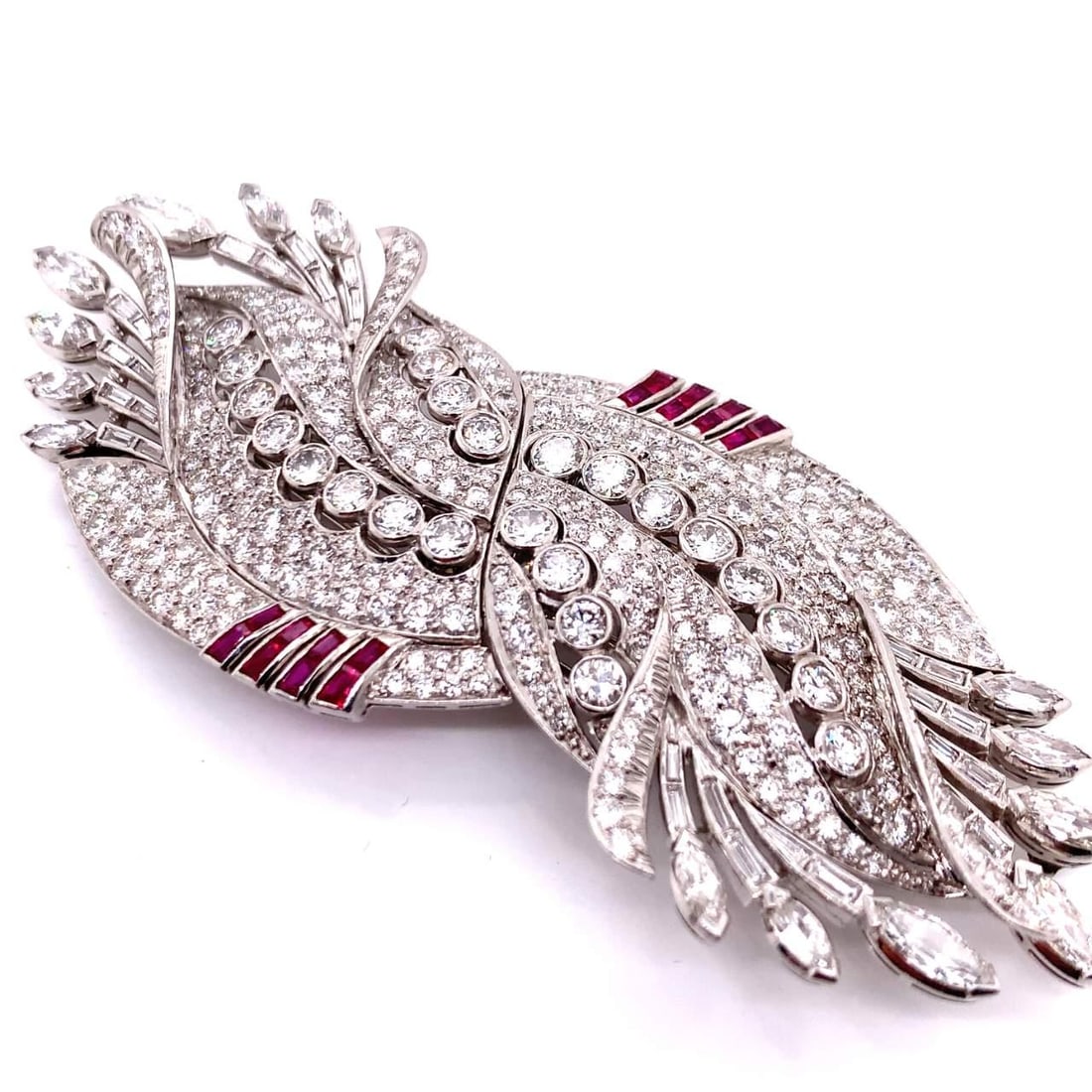 Art Deco Platinum Brooch 20Ct Diamonds 1Ct Rubies: Art Deco Platinum Brooch 20Ct Diamonds 1Ct Rubies This exquisite Art Deco brooch showcases a stunning combination of brilliance and color, featuring approximately 20.00 ct. of diamonds in D-F color wi