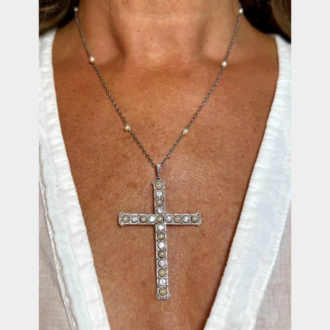 Art Deco Platinum Cross Necklace with Natural Pearls and Diamonds: Art Deco Platinum Cross Necklace with Natural Pearls and Diamonds This exquisite Art Deco Platinum Cross Necklace showcases a stunning array of natural pearls and diamonds. Weighing 10.5 grams, it fea