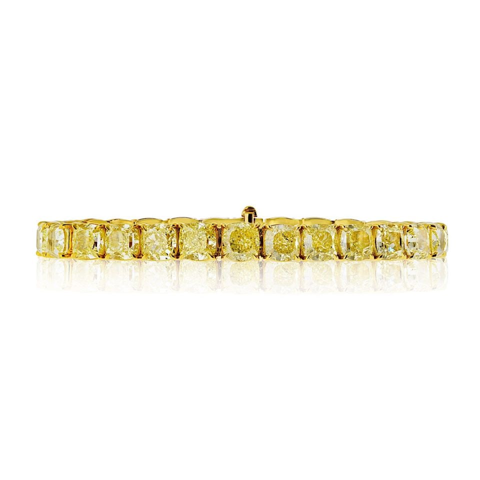 18K Yellow Gold 32.44 Cts GIA Fancy Light Yellow Diamond Bracelet: 18K Yellow Gold 32.44 Cts GIA Fancy Light Yellow Diamond Bracelet This stunning 18K yellow gold bracelet features 28 fancy light yellow cushion-cut diamonds, each GIA certified as natural earth-mined
