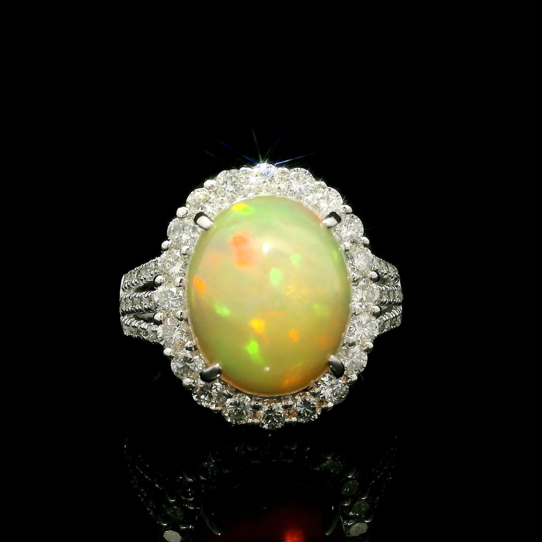 Large 7.23ctw Opal Diamond Halo Cocktail Ring in Platinum: Large 7.23ctw Opal Diamond Halo Cocktail Ring in Platinum This substantial cocktail ring features a stunning natural opal at its center, showcasing an exceptional play of colors in red, orange, and gr
