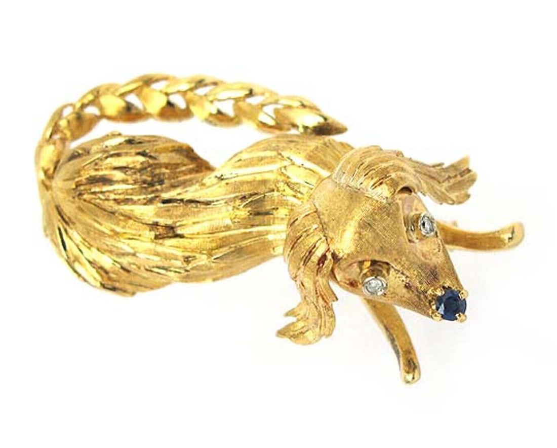 Vintage Dog Brooch in 18k Yellow Gold with Diamonds and Sapphires: Vintage Dog Brooch in 18k Yellow Gold with Diamonds and Sapphires This vintage brooch features a charming dog motif crafted in 18k yellow gold. The design is embellished with sparkling diamonds and sa