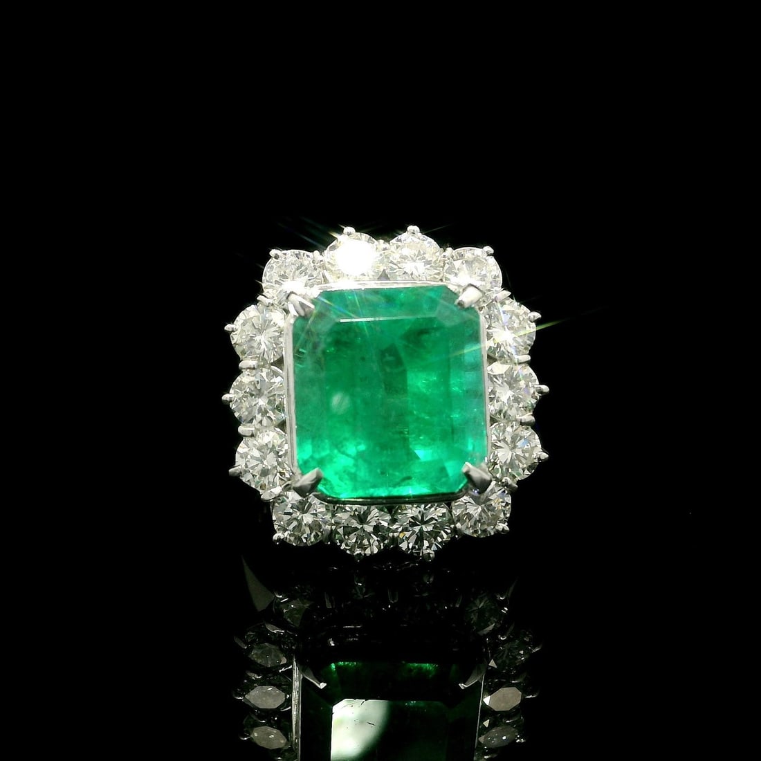 Platinum AGL 7.59ct Colombian Emerald Ring with Diamond Halo: Platinum AGL 7.59ct Colombian Emerald Ring with Diamond Halo This stunning cocktail ring features a magnificent 5.57ct natural Colombian emerald, expertly cut in a rectangular emerald shape and prong